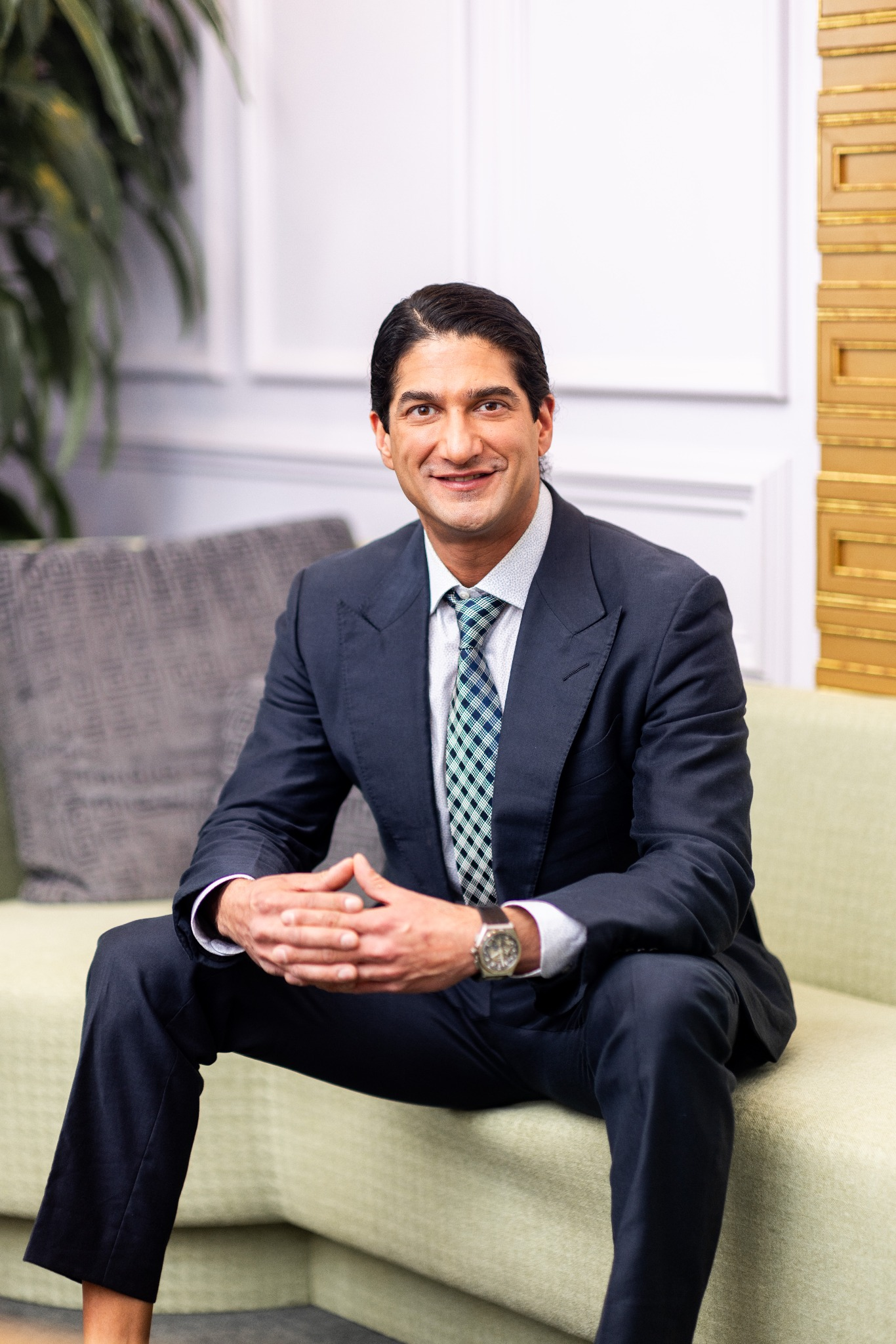 Dr. Omar Hussain, Beverly Hills rhinoplasty surgeon in a suit at The Practice