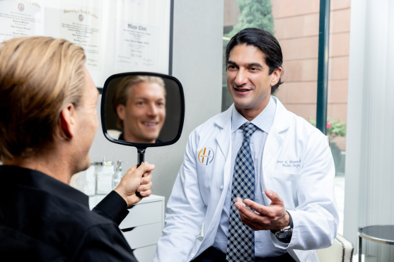 Dr. Omar Hussain consulting facelift patient during deep plane face lift discussion in Beverly Hills