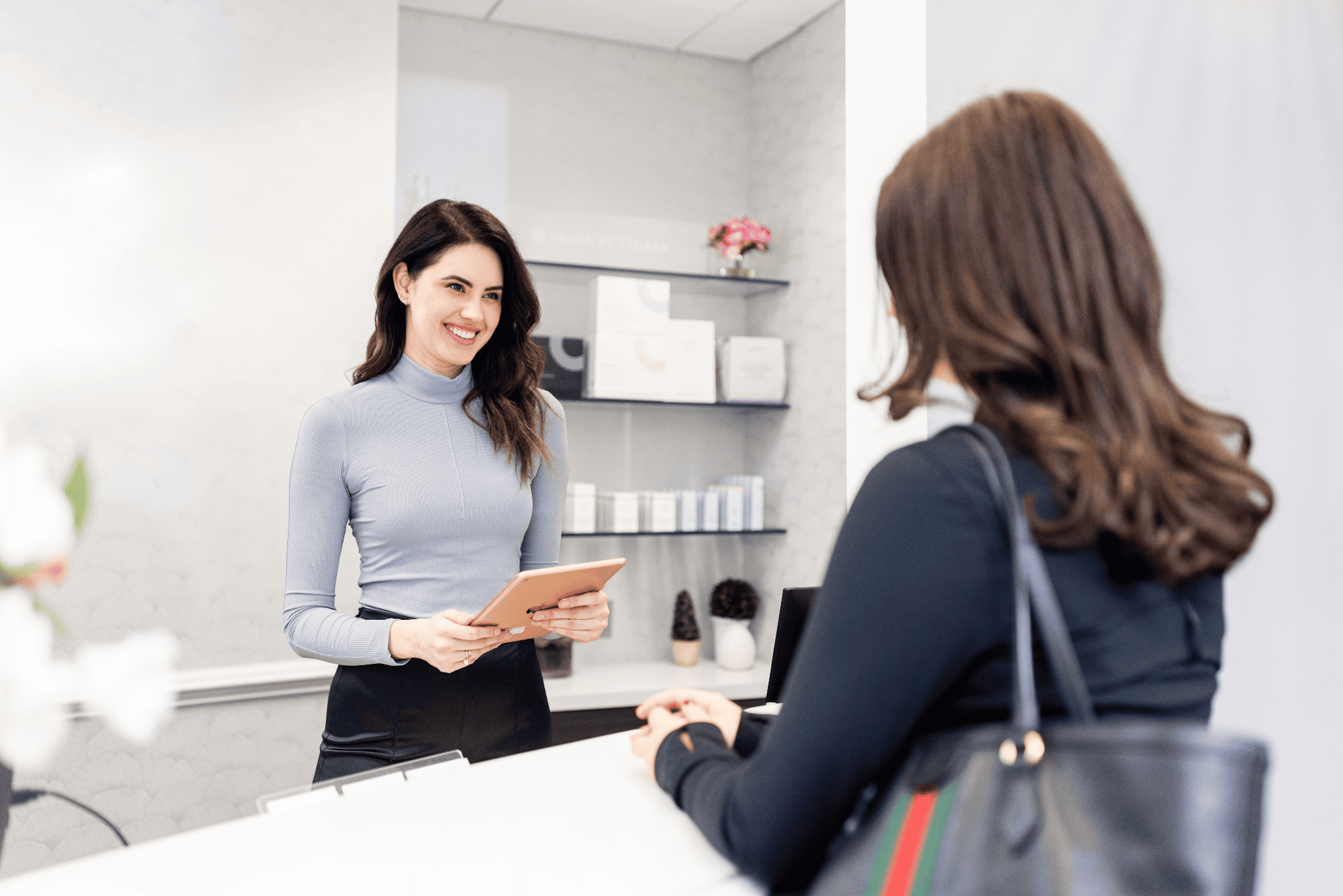 Patient check-in at the front desk for a tummy tuck consultation