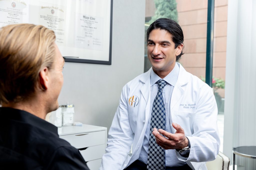 Dr. Omar Hussain discussing a personalized Botox treatment plan with a patient during a consultation