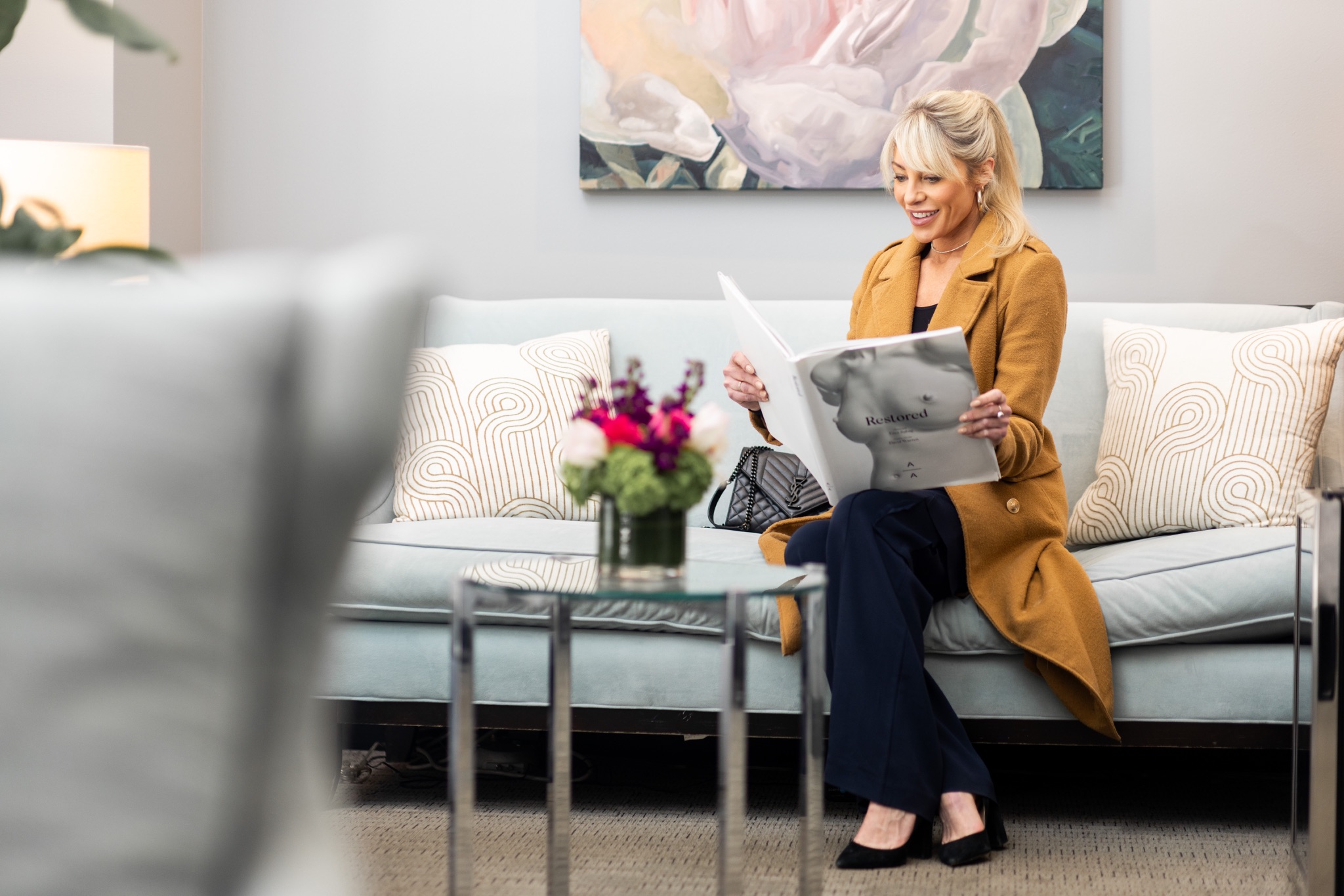 Patient browsing a lookbook in the waiting room before a skin tightening consultation Not everything marketed as a skin-tightening solution delivers clinically meaningful results.