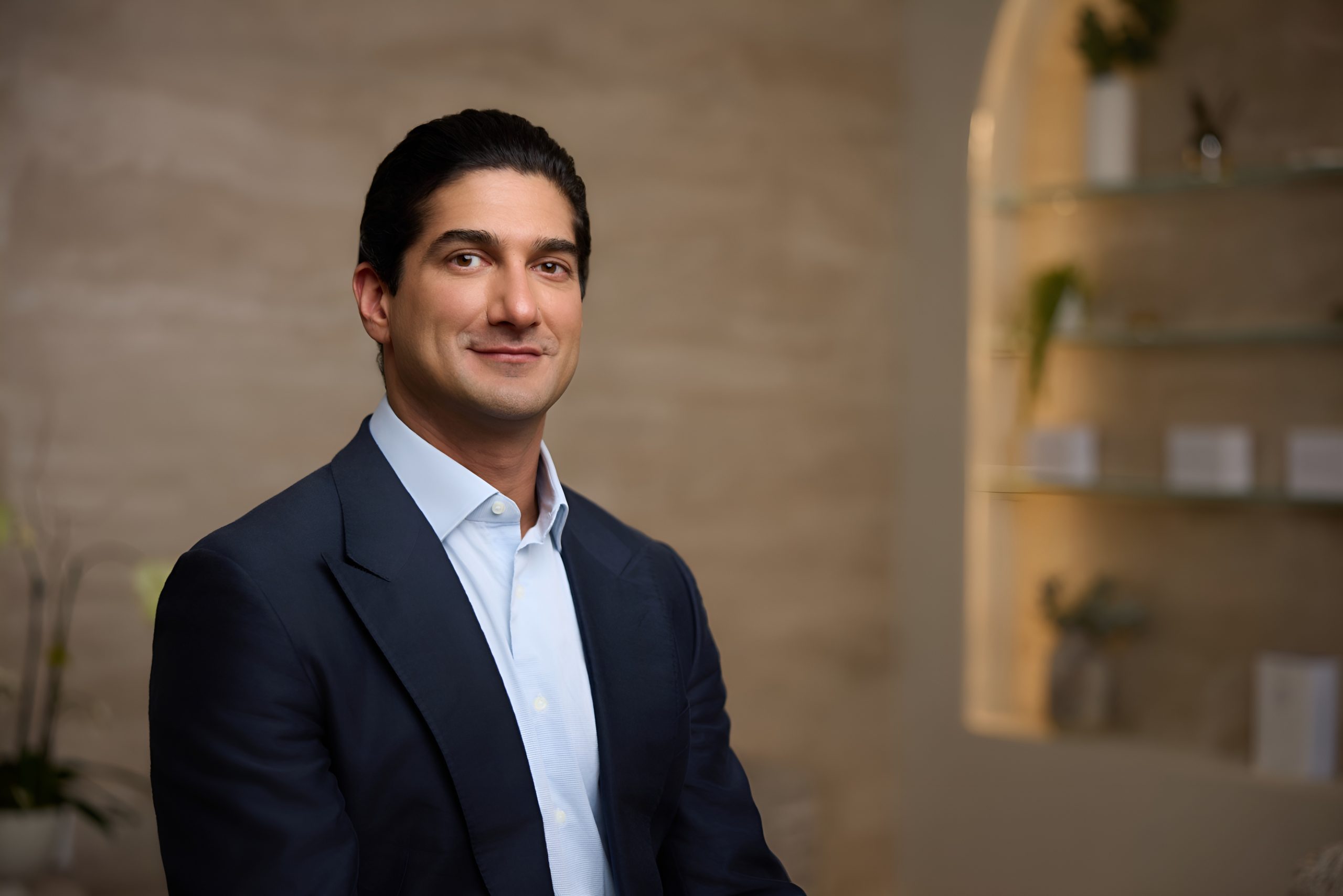 What a great facelift consultation looks like Portrait of a facelift surgeon in a navy blazer, showing the consultative, relationship-forward expertise that defines a high-quality surgical consult.